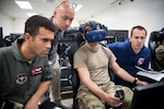 U.S. Air Force Capt. Jay Pothula, Det. 24 Pilot Training Next instructor; Derrick Ng, NASA aerospace engineer intern; and Alex Garbino, NASA extravehicular activities physiologist, monitors 2nd Lt. Gabe Cavender, PTN student, during a virtual reality sortie as part of the collaborative research agreement between Air Education and Training Command and NASA Oct. 22 at Joint Base San Antonio-Randolph. The goal of the agreement is to help both AETC and NASA collect physiological and cognitive data and leverage each organization's knowledge and skills to maximize learning potential for individual students.