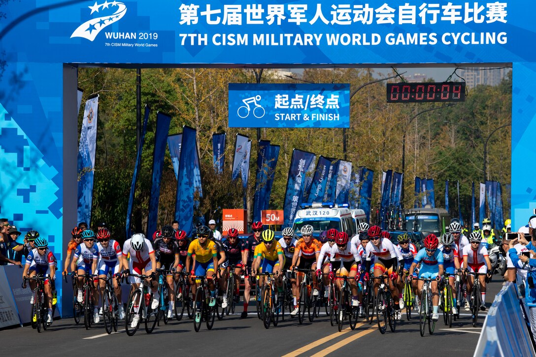 Dozens of cyclists take off from the starting line for a 50-mile road race.