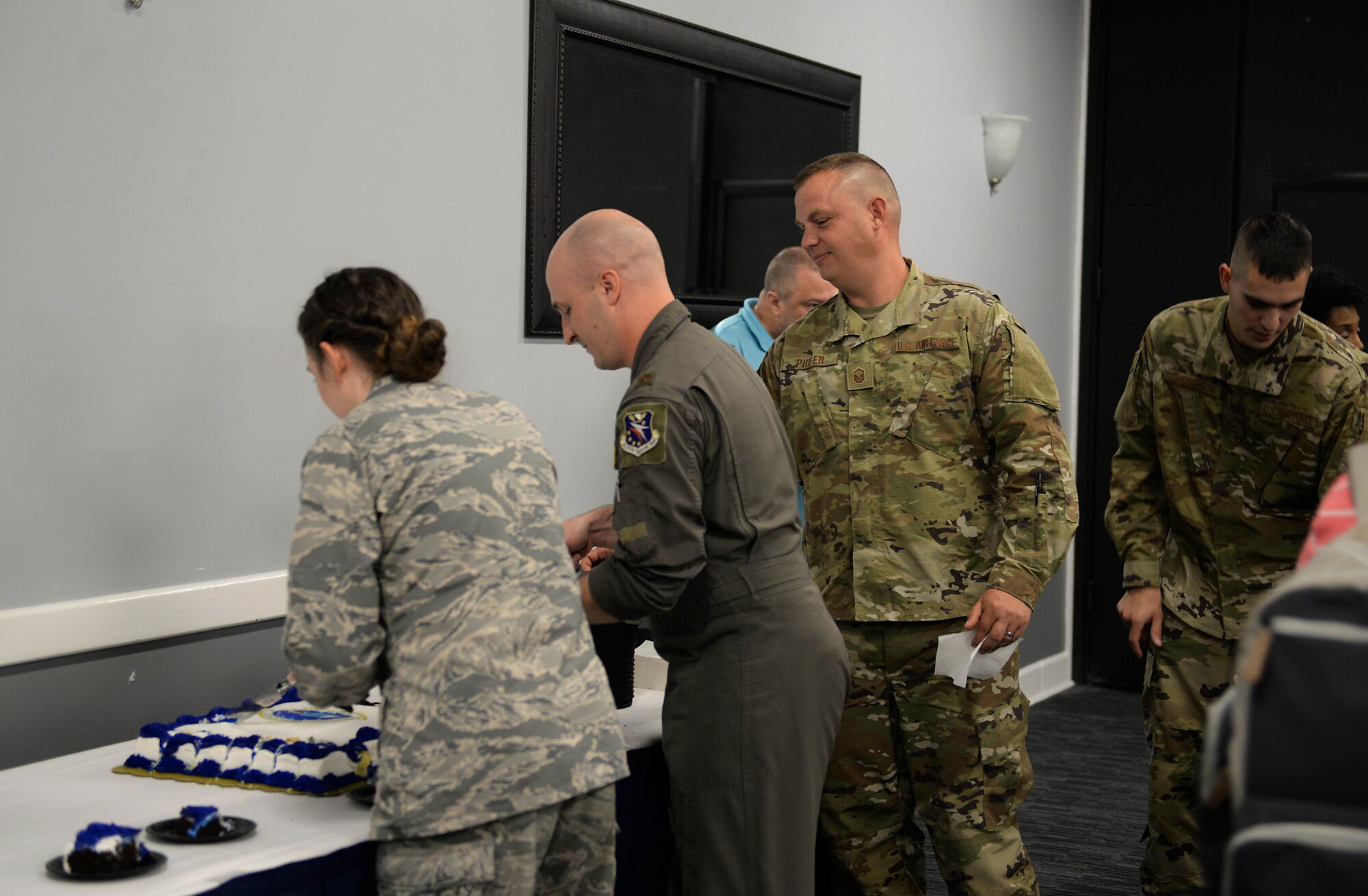 Attendees grab slices of cake during the Air Force’s 72nd Birthday at the Columbus Club Sept. 18, 2019, on Columbus Air Force Base, Miss. Before the creation of the Air Force, the military’s flying operations were handled by the U.S. Army on land and the Navy by sea. (U.S. Air Force photo by Airman 1st Class Hannah Bean)
