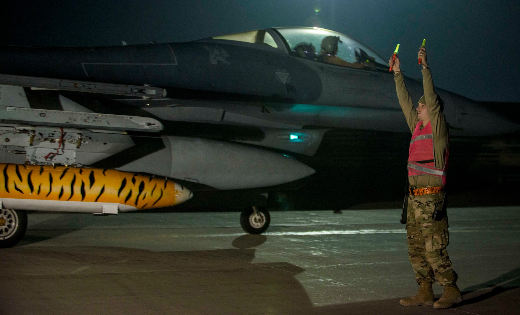 Airman 1st Class Blake Bullock, a crew chief from the 20th Aircraft Maintenance Squadron at Shaw Air Force Base, S.C., marshals F-16 Fighting Falcons upon their arrival at Bagram Airfield, Afghanistan, Oct. 25, 2019. While assigned to the 455th Air Expeditionary Wing at Bagram, the F-16s will help provide decisive airpower through the U.S. Central Command area of responsibility. The airpower the wing provides ensures NATO forces can focus on their mission to train, advise and assist.(U.S. Air Force photo by 2nd Lt. Brigitte N. Brantley)