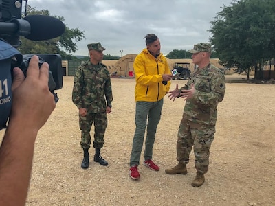 Command Sgt. Maj. William Rinehart, Army South command sergeant major, and Argemiro Posso Rivera, Colombian Military Senior Enlisted Advisor to the Joint Chiefs of Staff, conduct a television interview to talk about the strength of their army-to-army partnership at Joint Base San Antonio-Camp Bullis Oct. 24.