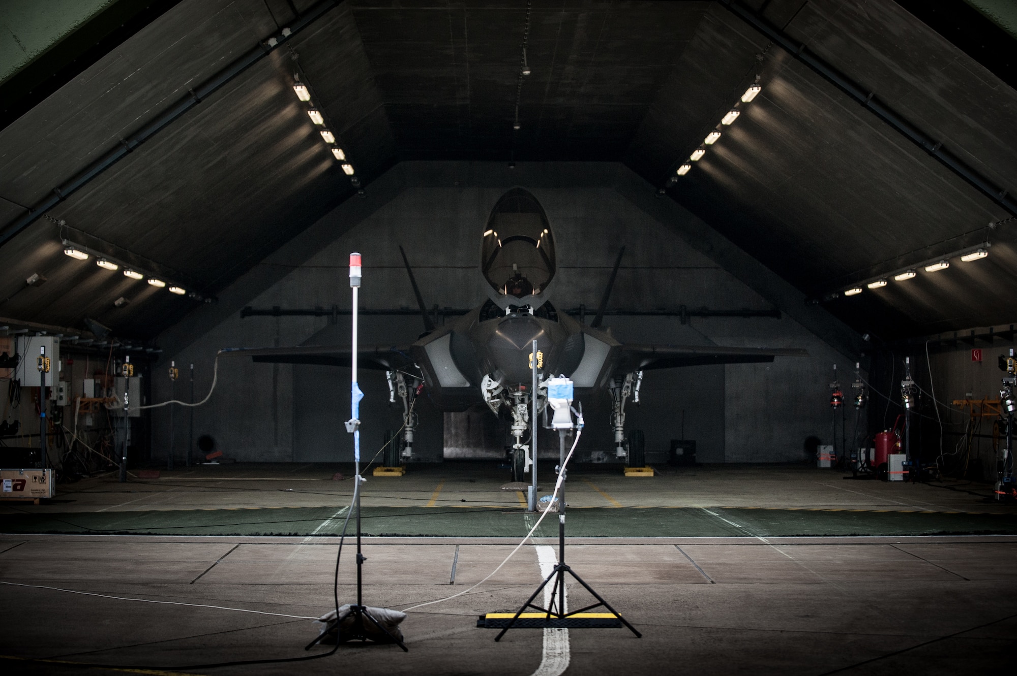 An F-35 is parked inside a hardened aircraft shelter in the Netherlands during an acoustics and air quality testing session, led by experts in the Air Force Research Laboratory’s 711th Human Performance Wing. Microphones are attached to the skin of the fighter, to the pilot in the cockpit, and to maintainer areas in front to measure and collect data for an official report. (Photo courtesy of Royal Netherlands Air Force)
