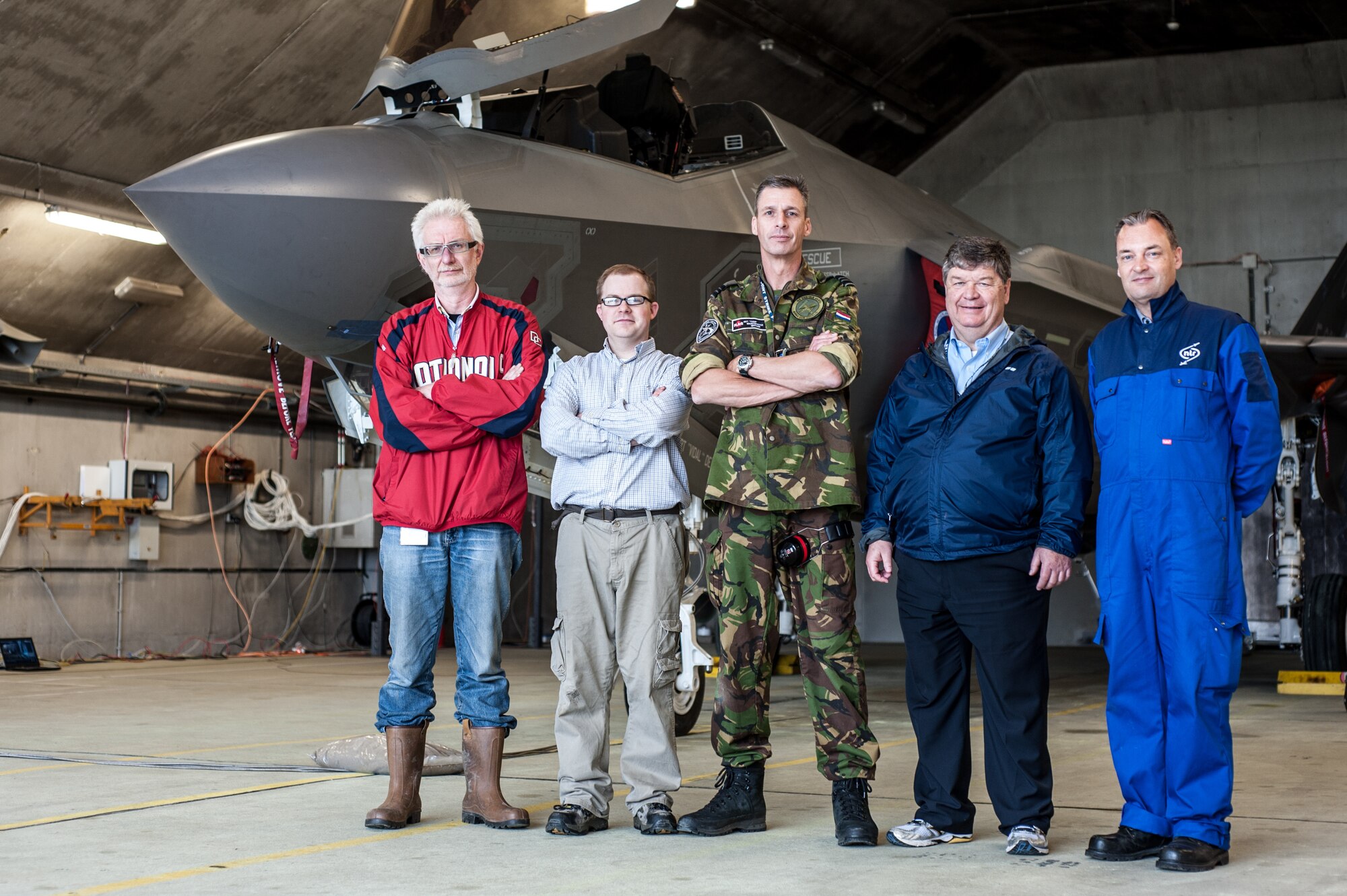 (left to right) Jaap van ‘t Hof, with the Netherlands TNO Laboratory; Alan Wall, with the U.S. Air Force Research Laboratory; Maj. Arthur L. Driesen, with the Royal Netherlands Air Force; Richard McKinley, with the U.S. Air Force Research Laboratory (now retired); and Theo van Veen, with the Netherlands Aerospace Centre, stand in front of the F-35 used during an acoustics testing session, led by experts in AFRL’s 711th Human Performance Wing. (Photo courtesy of Royal Netherlands Air Force)