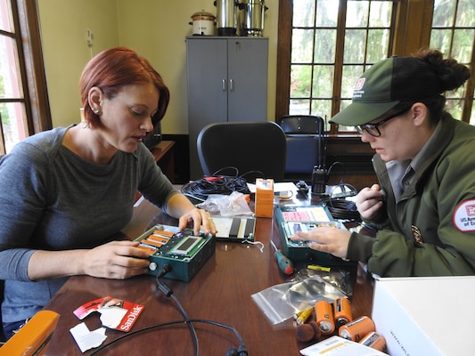 Rhonda Lucas and Ranger Katie McGillvray program bat monitoring equipment to record bat calls at Lake Washington Ship Canal.