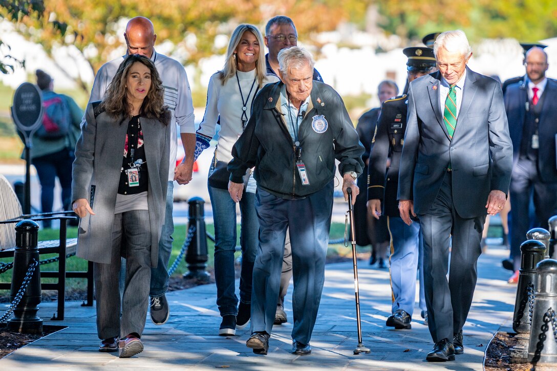 A group of people walk.