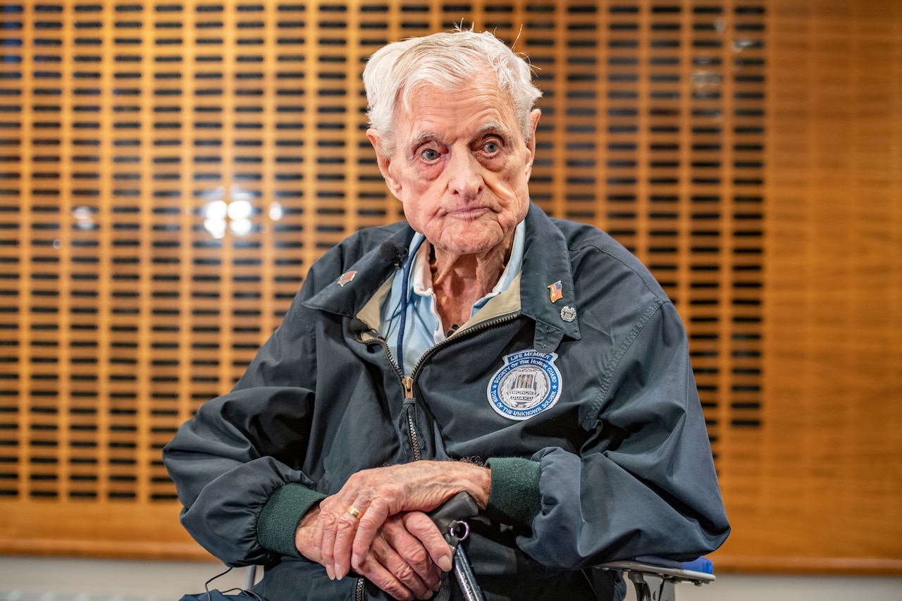 An elderly man sitting.