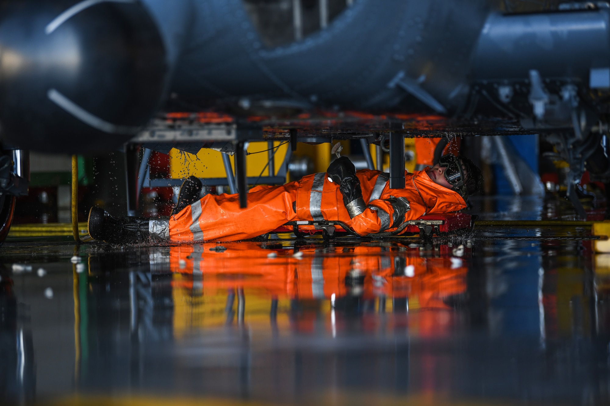 Airman washes under an HH-60G Pave Hawk