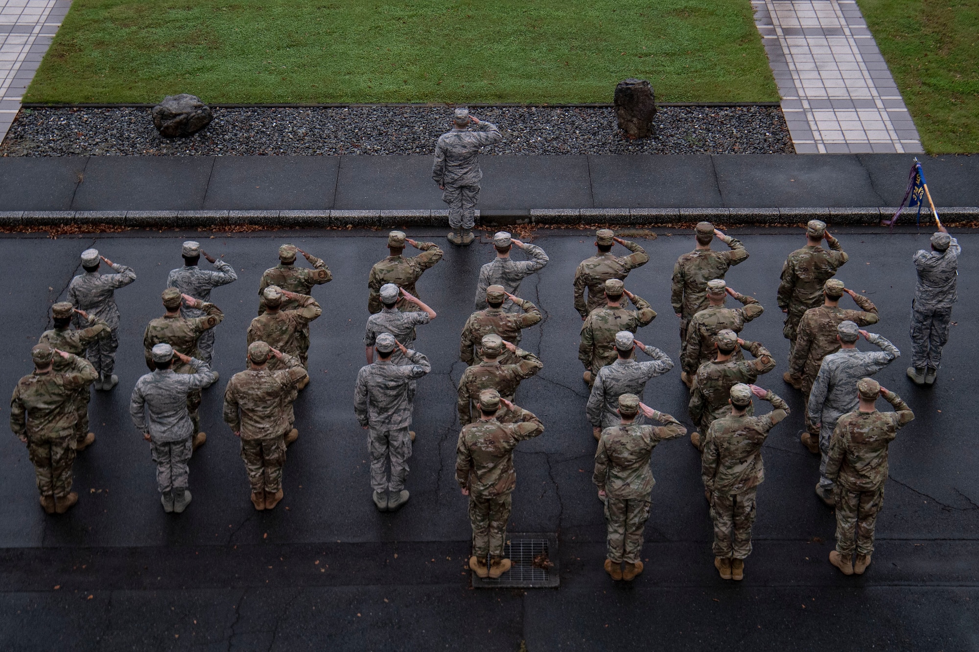 Airmen salute during a retreat ceremony