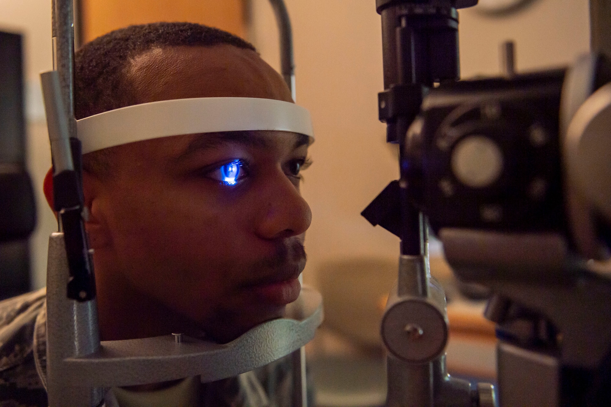 Optometry technician examines a patient