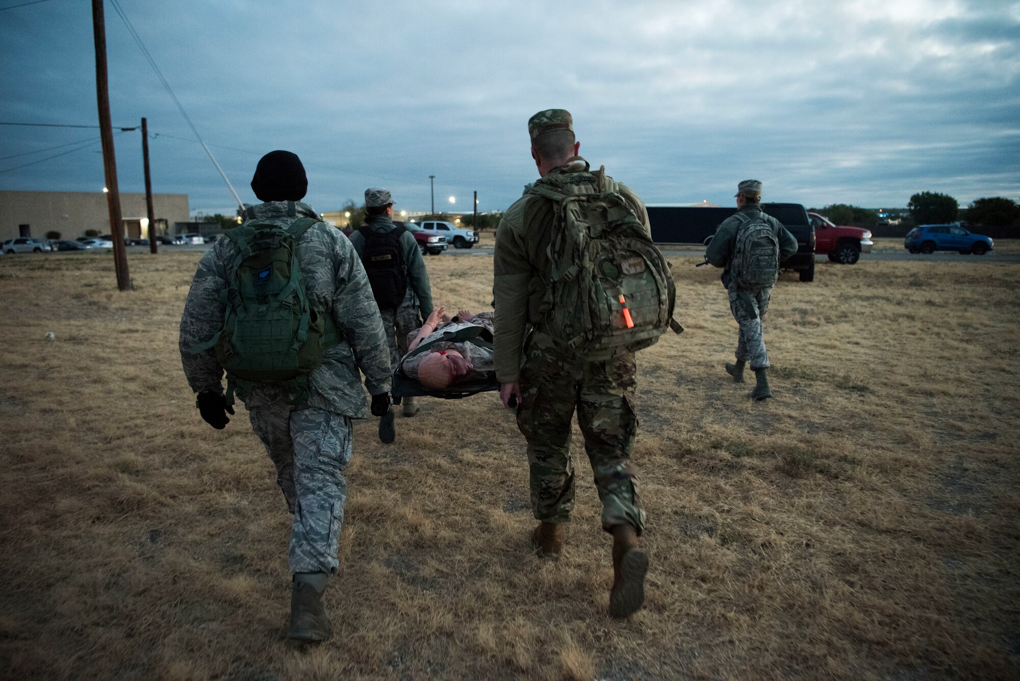 A team of Airmen assigned to the 47th Operational Medical Readiness Squadron approach the finish point with a casualty during a readiness exercise at Laughlin Air Force Base, Texas, Oct. 25, 2019. Medical dummies as well as one Airmen played the role of being a casualty to simulate real world scenarios as teams of Medics practiced their life saving skills. (U.S. Air Force photo by Senior Airman Marco A. Gomez)