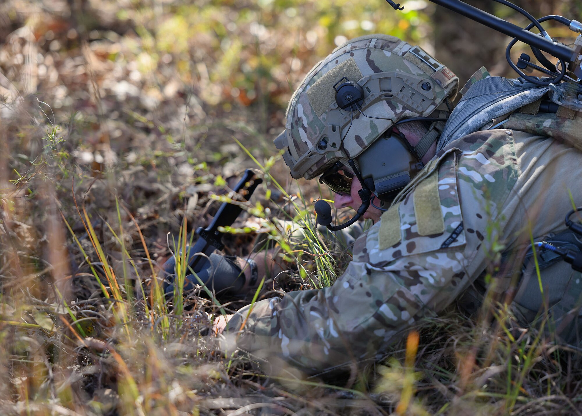 U.S. Air Force Staff Sgt. Htyler Kelley, 19th Civil Engineer Squadron Explosive Ordnance Disposal technician, uncovers a simulated improvised explosive device during a Joint training exercise at Camp Robinson, Arkansas, Oct. 22, 2019.