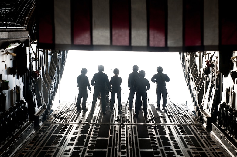 Airmen step toward the ramp of a C-17 Globemaster III
