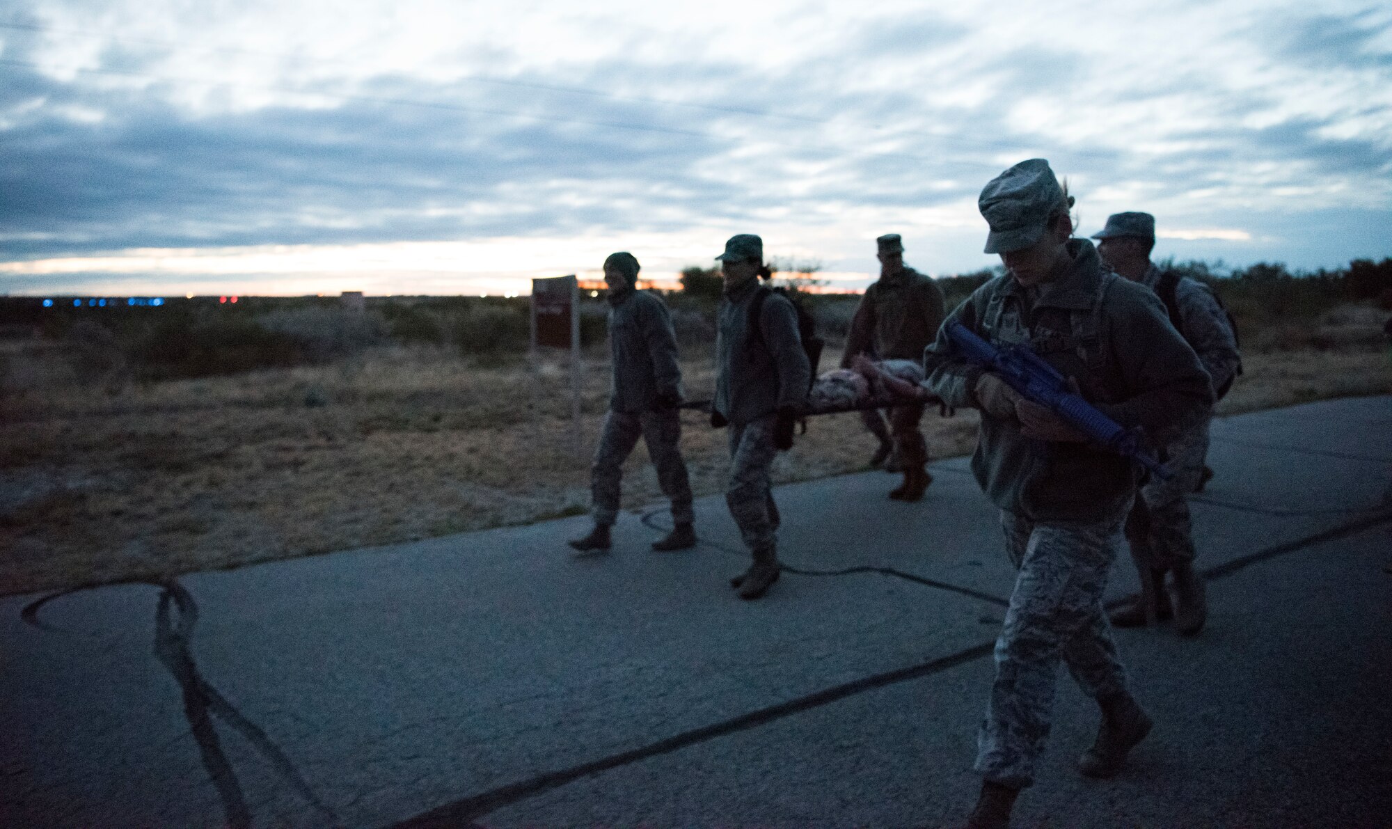 Tech Sgt. Michele Lazurka, 47th Operational Medical Readiness Squadron flight medicine office manager, escorts a team of medics to the exercise final destination at Laughlin Air Force Base, Texas, Oct. 25, 2019. The medics were faced with the challenge of extracting the casualties in less than an hour back to the starting point. (U.S. Air Force photo by Senior Airman Marco A. Gomez)