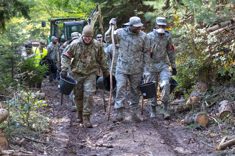 Airmen have worked in the dense wooded area digging through thick vegetation to recover F-16 parts.
