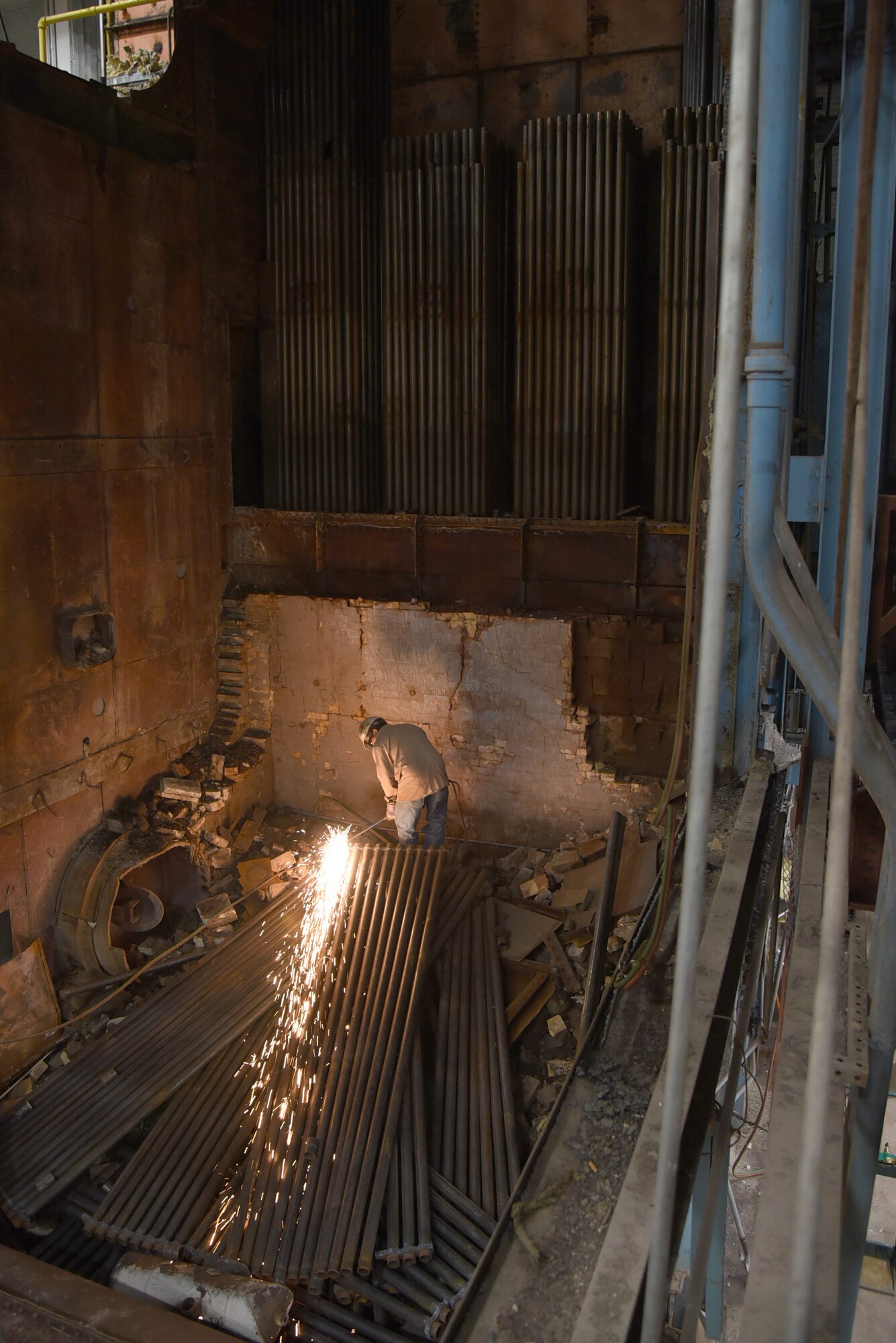 An image of a construction worker in the demolition site of Boiler #1.