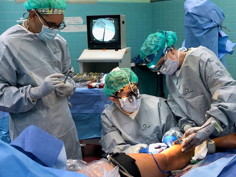 (From Left) Army Spc. Abdiel Santos-Soto, Air Force Maj. Julia Nuelle and Air Force Capt. Tayt Ellison harvest bone to perform a fibular bone graft Sept. 19 during a Medical Readiness Exercise in Tegucigalpa, Honduras. A team of 19 military medical personnel from Brooke Army Medical Center and other military treatment facilities completed 128 procedures from Sept. 14-27.