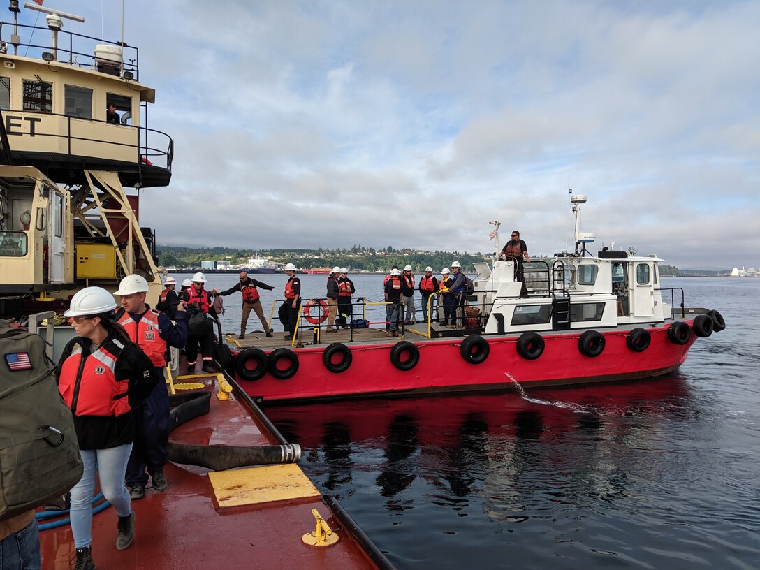 Students participating in the Northwest Oil Spill Control Course transfer from an Arrow Launch Service vessel to the M/V Puget. As part of an international cooperation to prepare for a hazardous spill response on Puget Sound, Seattle District participated in the Northwest Oil Spill Control Course hosted by the United States Coast Guard, District 13 August 26-30. (USACE photo by Brad Schultz)