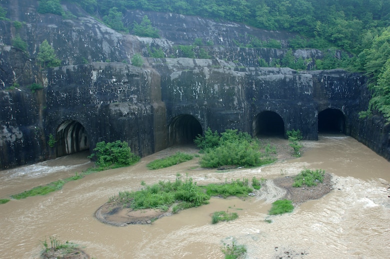 Water from the Clover Fork River, tributary of the Cumberland River, flows through the Harlan Tunnels in Harlan, Ky., May 25, 2011. The U.S. Army Corps of Engineers Nashville District diverted the waterway through the tunnels and around the Harlan Business District Sept. 21, 1992 as part of phase one of the Harlan Flood Control Project. Officials dedicated the overall completion of the project Oct. 25, 1999. (USACE Photo)