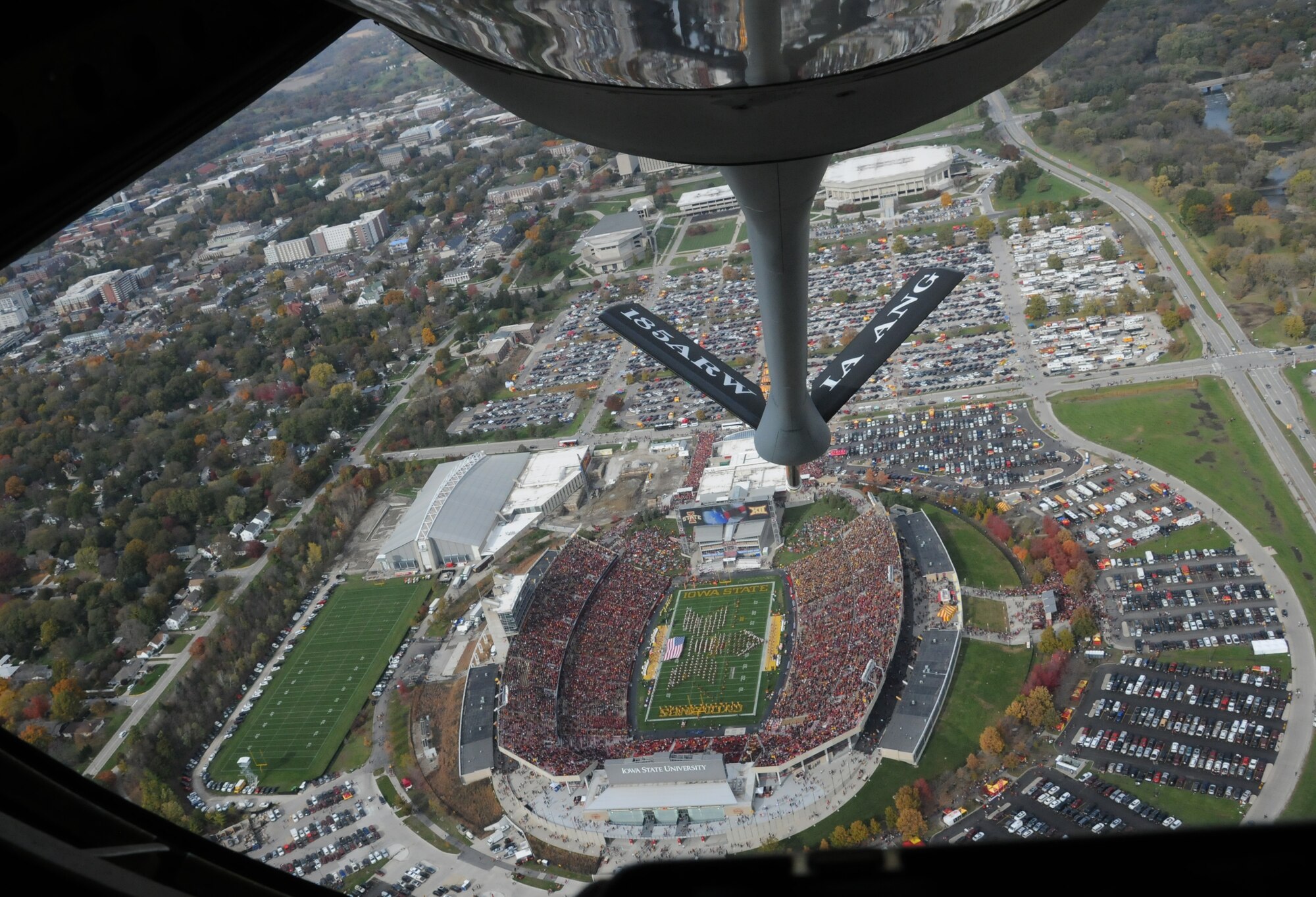 The boom of a KC-135 Stratotanker can be seen as the aircraft flies over Jack Trice Stadium.