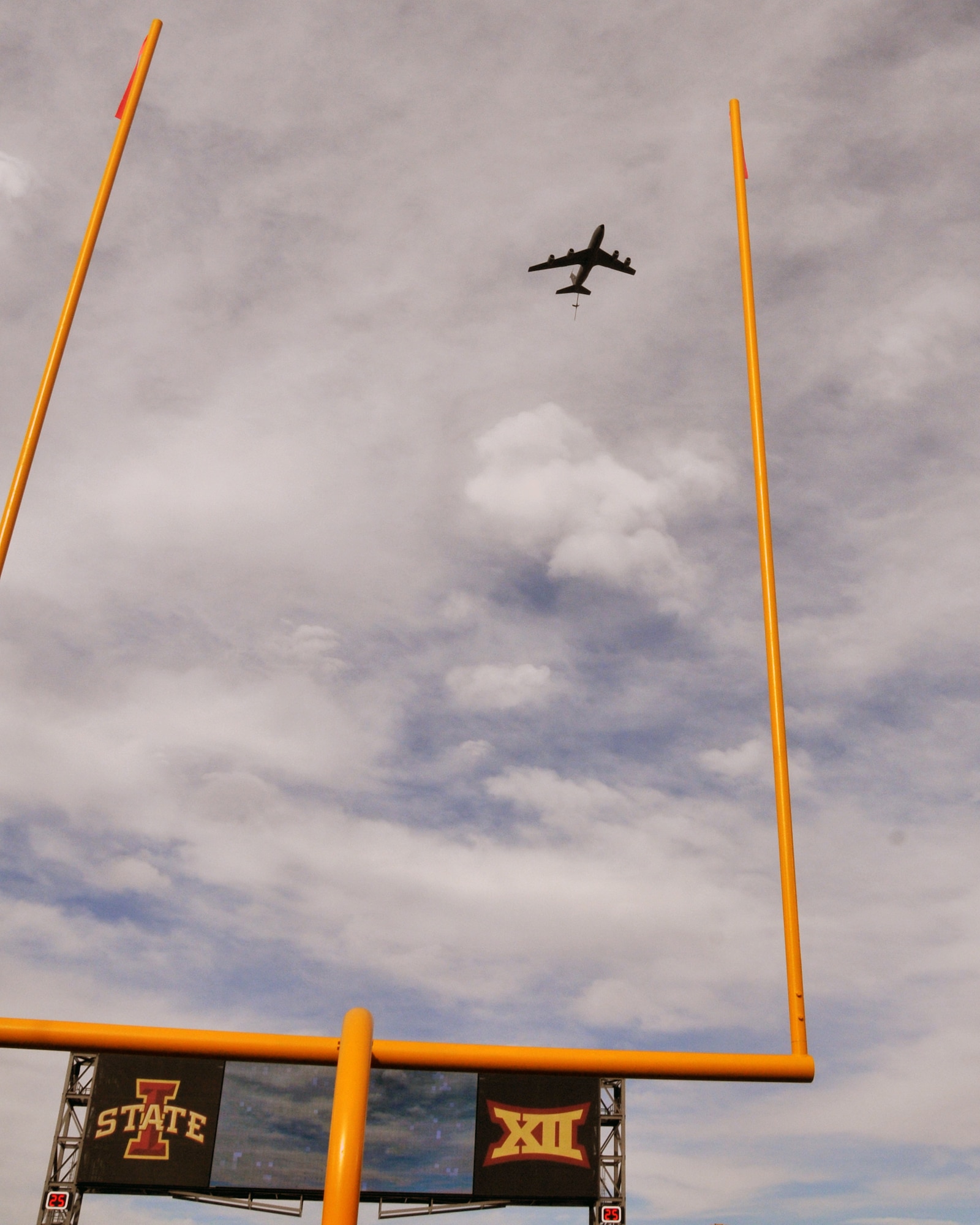 A KC-135 can been seen through the goal posts at Jack Trice Stadium in Ames, Iowa as it passes overhead.