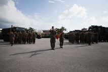 U.S. Marines with Truck Company, Headquarters Battalion, 3rd Marine Division, stand in formation during a change of command ceremony on Camp Hansen, Okinawa, Japan, Oct. 25, 2019. The ceremony was held for U.S. Marine Corps Capt. Matthew Dorton, the oncoming company commander for Truck Company, who relieved U.S. Marine Corps Capt. Marie Banks, the outgoing company commander of Truck Company. During the ceremony, the transfer of the company colors, symbolizing the transfer of responsibility and authority of Truck Company, was performed by the outgoing and incoming commanders.