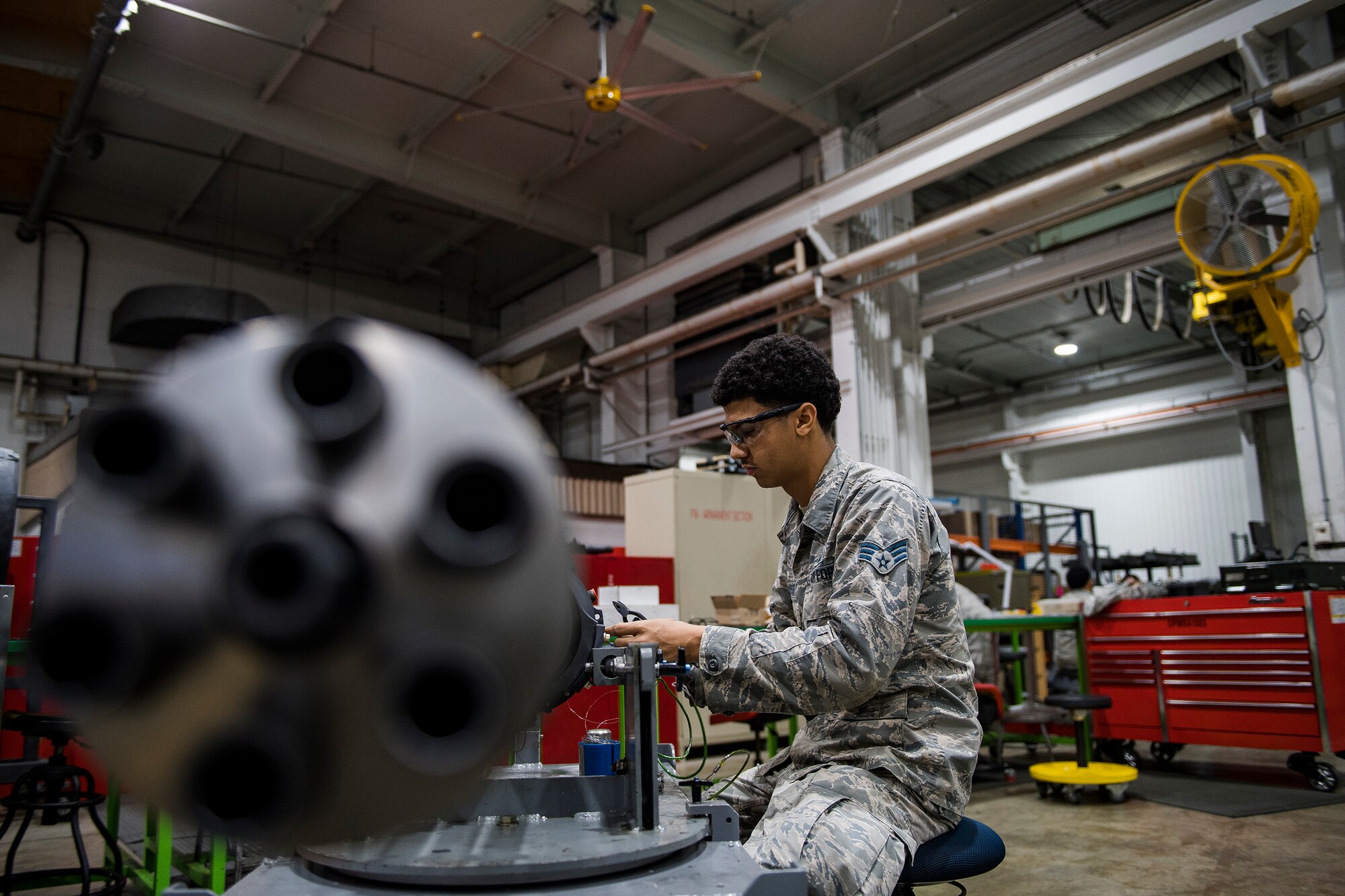 Senior Airman Jordan Harrison, 51st Munitions Squadron F-16 armament systems technician, fixes a component on an F-16 20mm gun, Oct. 23, 2019, at Osan Air Base, Republic of Korea. Born just one minute apart, Jordan and his fraternal brother Quinn have been inseparable “wingmen” since birth. They recently reunited and both serve in the 51st Munitions Squadron as members of the friendly rivaled armament and ammo sections. (U.S. Air Force photo by Staff Sgt. Greg Nash)