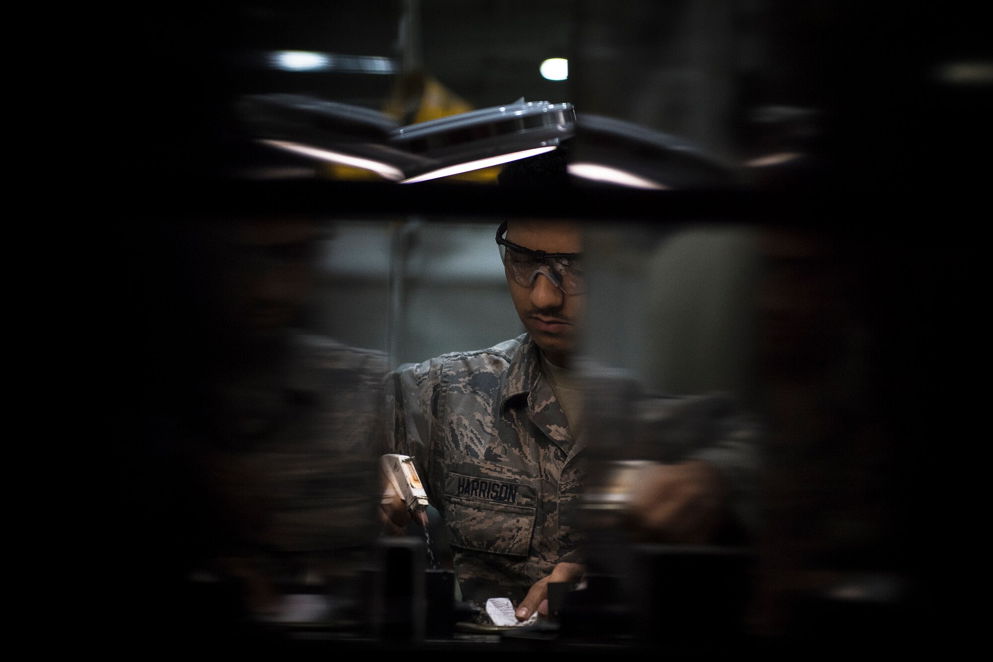 Senior Airman Jordan Harrison, 51st Munitions Squadron F-16 armament systems technician, sprays a MAU-12 ejector rack before assembling an F-16 20mm gun, Oct. 23, 2019, at Osan Air Base, Republic of Korea.