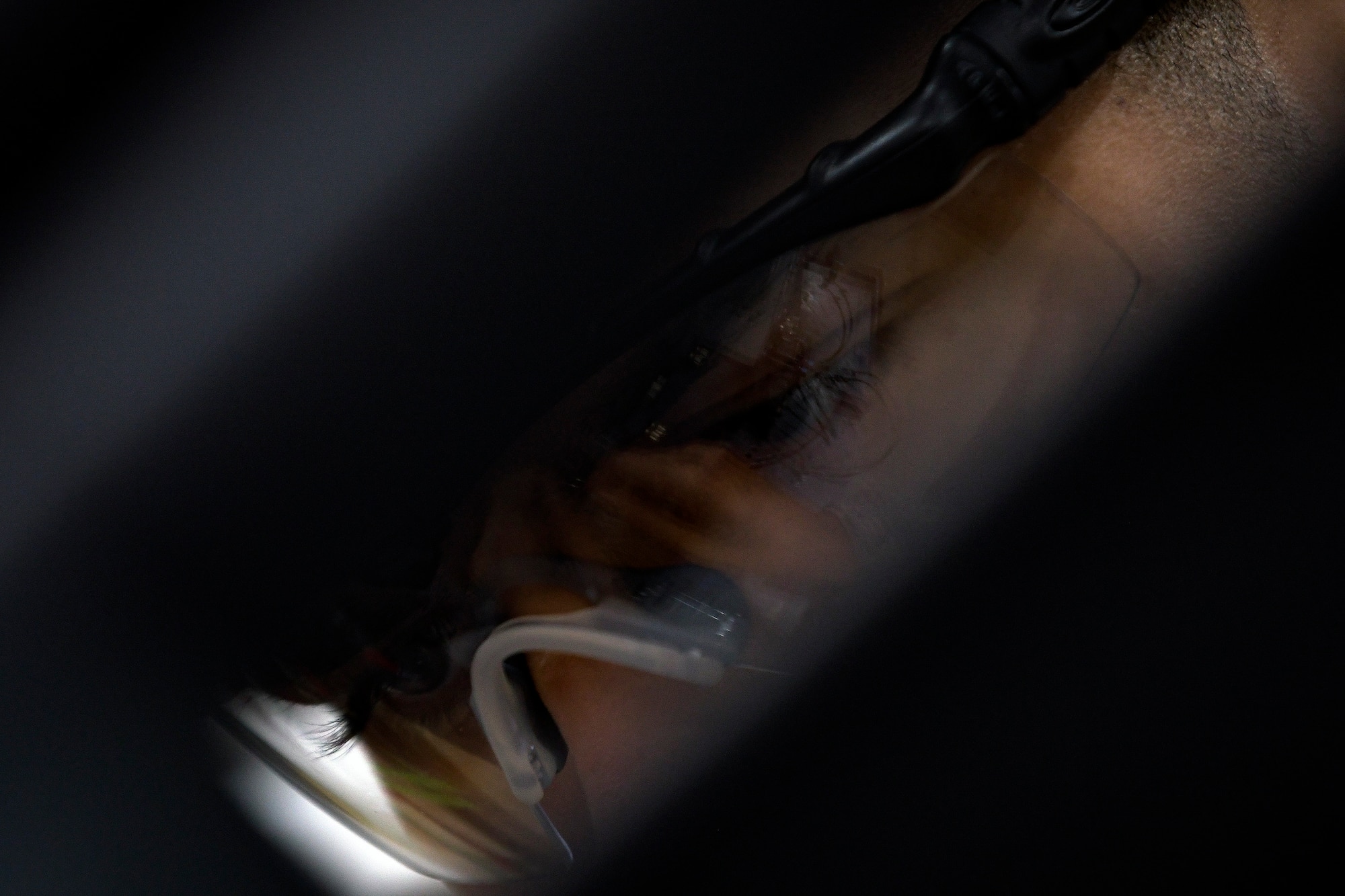 An eye protection reflection shows the hands of Senior Airman Jordan Harrison, 51st Munitions Squadron F-16 armament systems technician, fixing the components on an F-16 20mm gun, Oct. 23, 2019, at Osan Air Base, Republic of Korea.