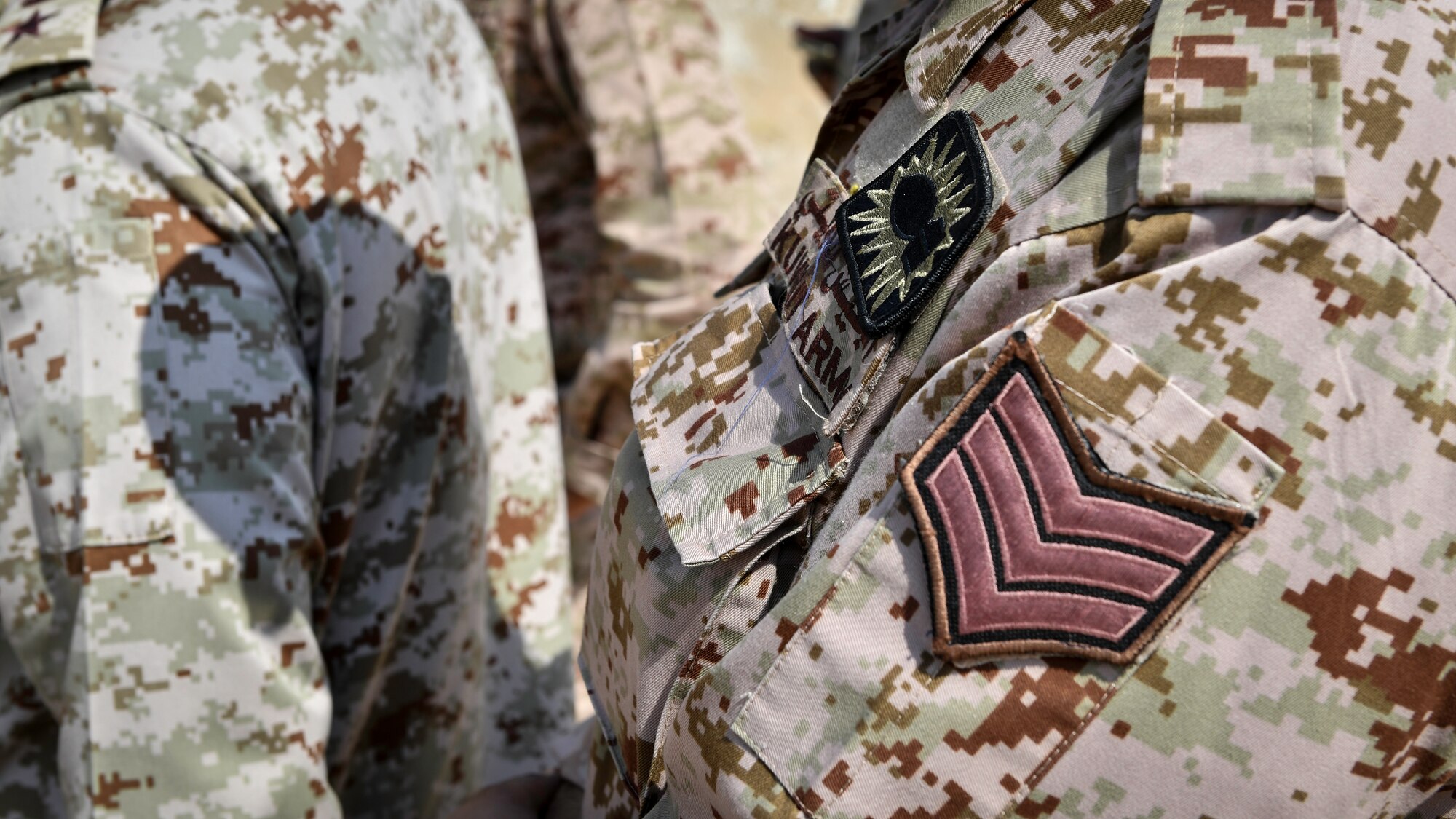 An explosive ordnance disposal badge is worn by a Kuwaiti Ministry of Defense EOD technician during an insensitive munitions training at the Udari Range, Kuwait, Sept. 26, 2019. The EOD badge is a military badge that recognizes service members as qualified EOD technicians who are specially trained to deal with the construction, deployment, disarmament and disposal of high explosive munitions. EOD technicians worldwide use the same basic badge design with minute design differences.
