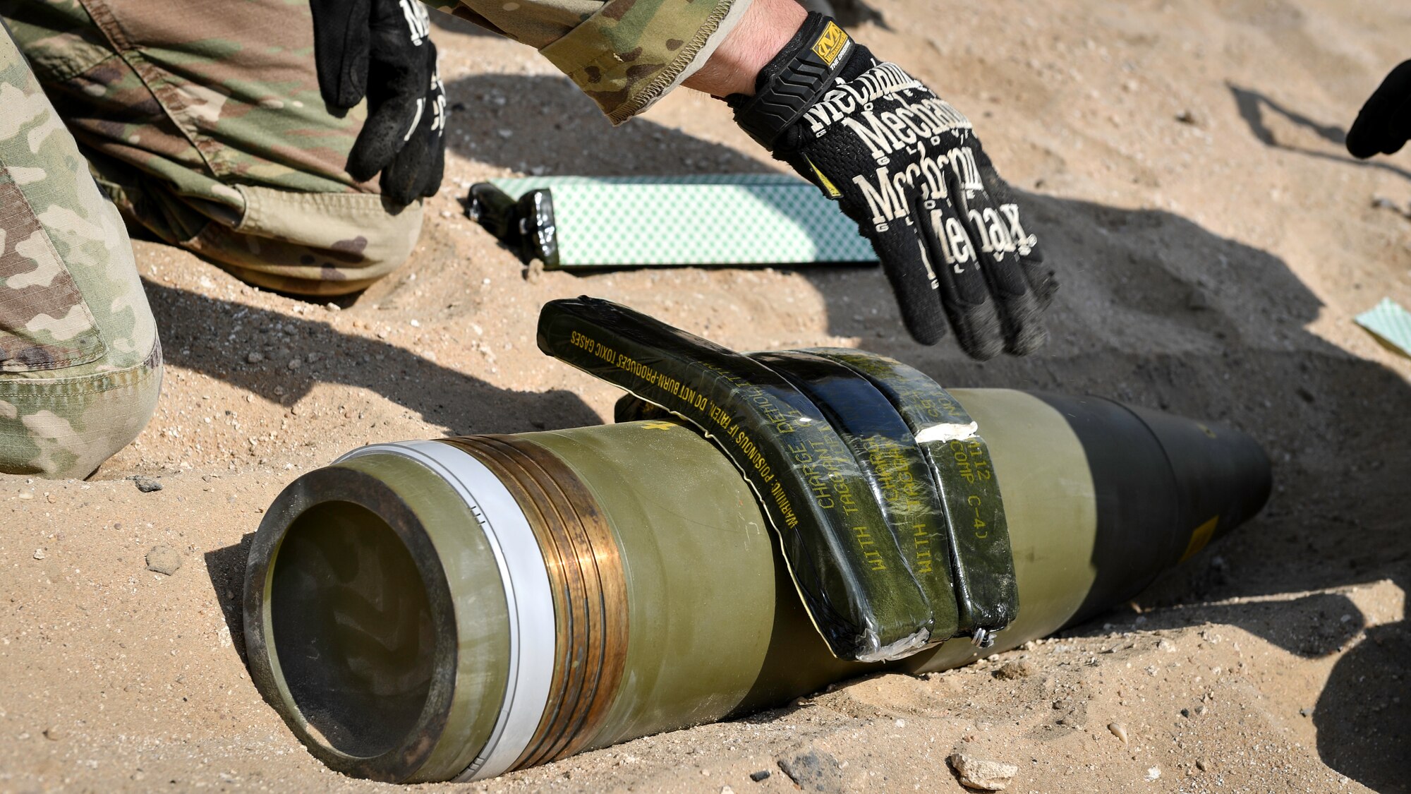 U.S. Army Sgt. 1st Class Jesse Harris, 744th Ordnance Company operations sergeant, places C-4 high explosives on to a 155MM insensitive high explosive round before a munitions disposal training at the Udari Range, Kuwait, Sept. 30, 2019. C-4’s high cutting ability when detonated makes it the ideal explosive to use in disposal or controlled detonations of insensitive high explosive rounds.