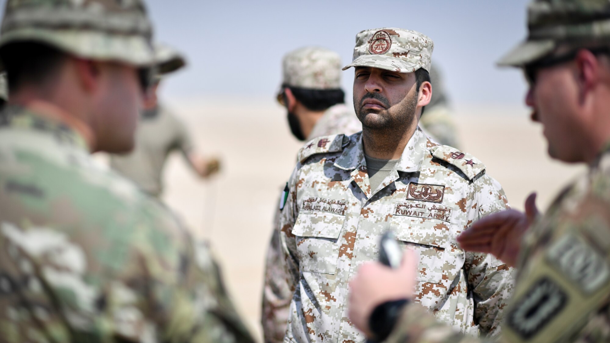 U.S. Army and Kuwaiti Ministry of Defense EOD technicians discuss insensitive high explosive munitions detonation techniques before a munitions disposal training at the Udari Range, Kuwait, Sept. 30, 2019. The training was designed for U.S. and Kuwaiti forces to share techniques, synchronize capabilities and build partnerships