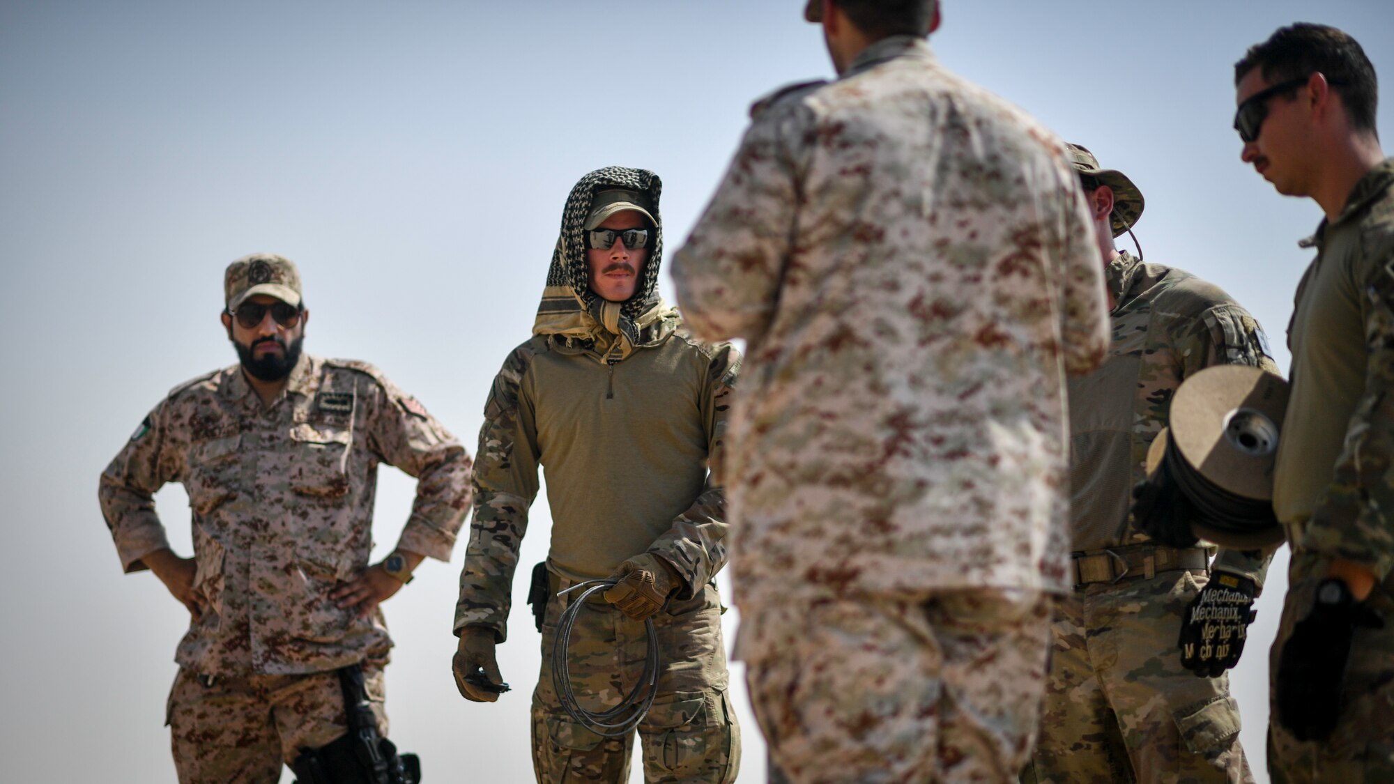 U.S. Army and Kuwaiti Ministry of Defense EOD technicians discuss insensitive high explosive munitions detonation techniques before a munitions disposal training at the Udari Range, Kuwait Sept. 30, 2019. The training was designed for U.S. and Kuwaiti forces to share techniques, synchronize capabilities and build partnerships.