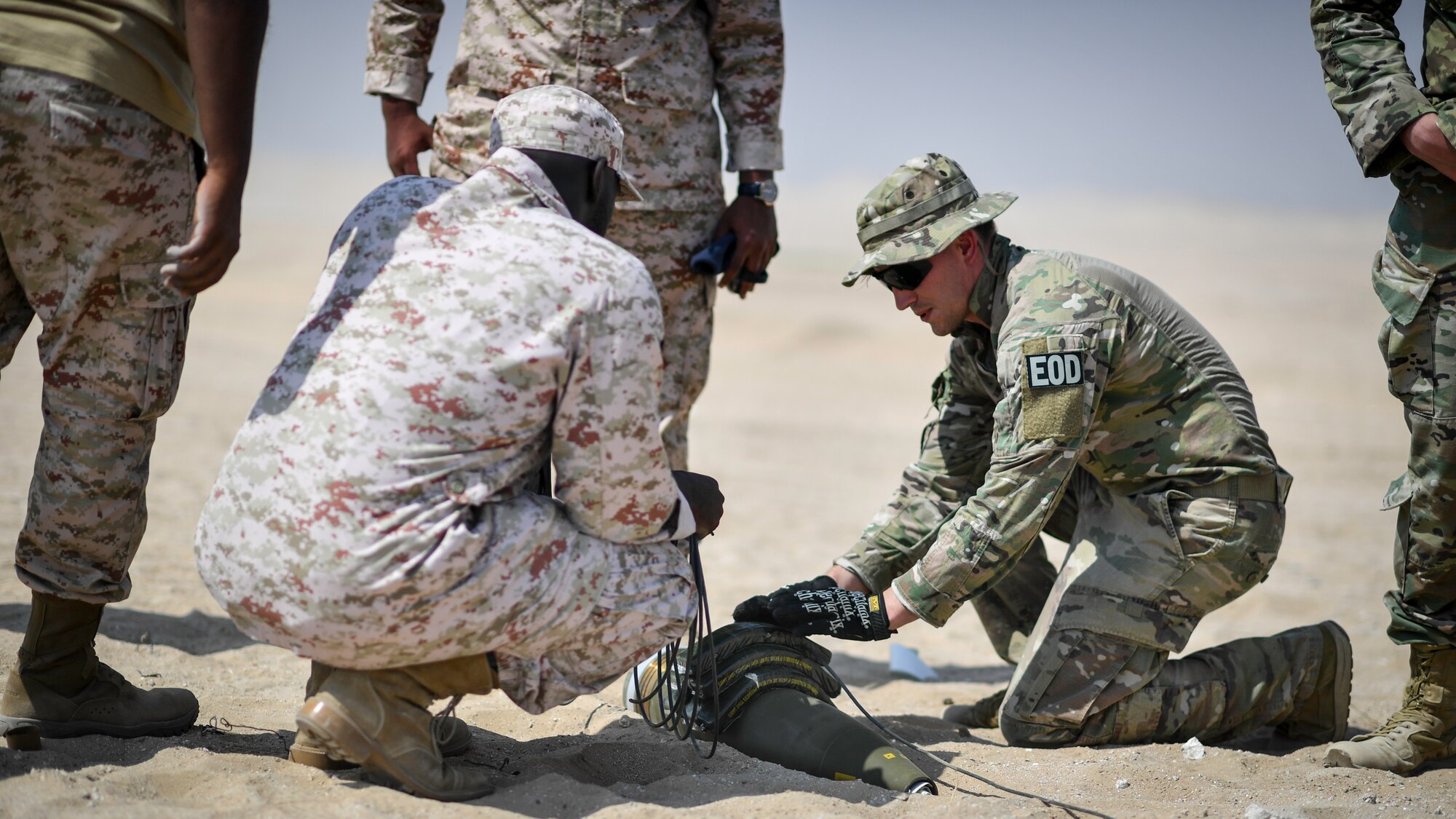 U.S. Army Sgt. 1st Class Jesse Harris, 744th Ordnance Company operations sergeant, places C-4 high explosives on to a 155MM insensitive high explosive round before a munitions disposal training at the Udari Range, Kuwait, Sept. 30, 2019. C-4’s high cutting ability when detonated makes it the ideal explosive to use in the disposal or controlled detonations of insensitive high explosive rounds.