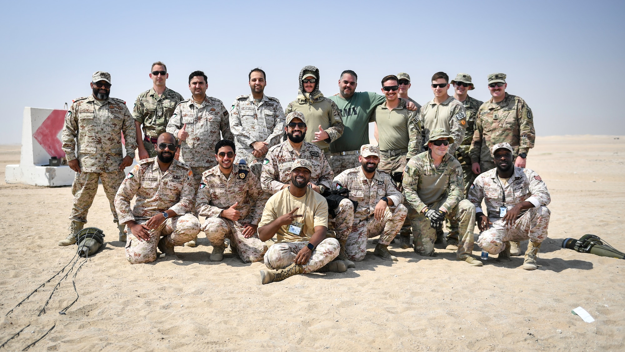 U.S., Kuwaiti and British EOD technicians pose for a group photo at the conclusion of munitions disposal training at the Udari Range, Kuwait, Sept. 30, 2019. The training was designed for U.S. and Kuwaiti forces to share techniques, synchronize capabilities and build partnerships by sharing knowledge and experience.