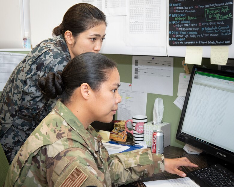 Staff Sgt. Amanda Nanpei, 374th Logistics Readiness Squadron aircraft part store supervisor, teaches Koku-Jieitai Staff Sgt. Satomi Ogasawara, 3rd Air Depot materiel management, assigned to Iruma Air Base, Japan, how to record aircraft parts that have been relocated, during a Bilateral Exchange Program, Oct. 21, 2019, at Yokota Air Base, Japan.