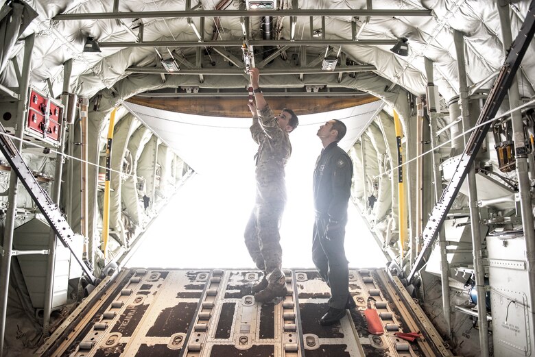 Staff Sgt. Hector Frietze, 36th Airlift Squadron loadmaster, shows how they perform pre-flight inspections inside a C-130J Super Hercules to Koku-Jieitai Tech. Sgt. Hideki Tanaka, 403rd Tactical Airlift Squadron loadmaster assigned with Miho Air Base, Japan, during the Bilateral Exchange Program, Oct. 22, 2019, at Yokota Air Base.