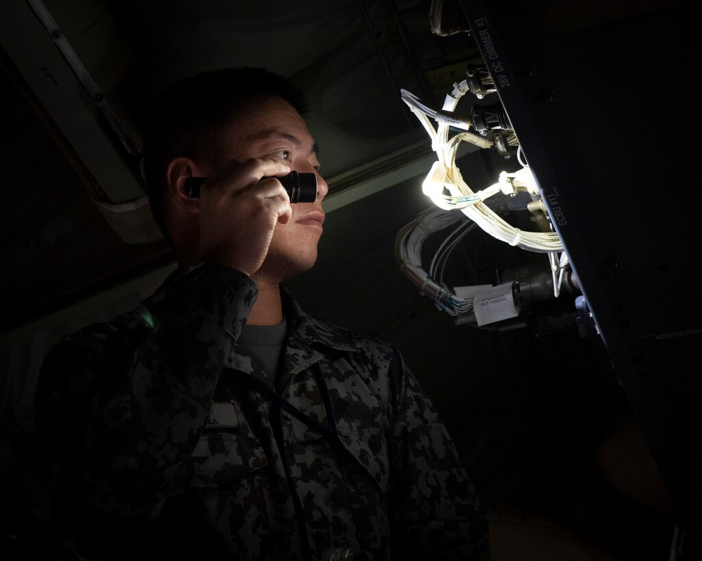 Koku-Jieitai Tech. Sgt. Ryo Matahira, Air Rescue Wing Maintenance Group aircraft maintenance assigned with Komaki Air Base, Japan, checks an antenna controller installed in C-130J Super Hercules during a Bilateral Exchange Program, Oct. 24, 2019, at Yokota Air Base.