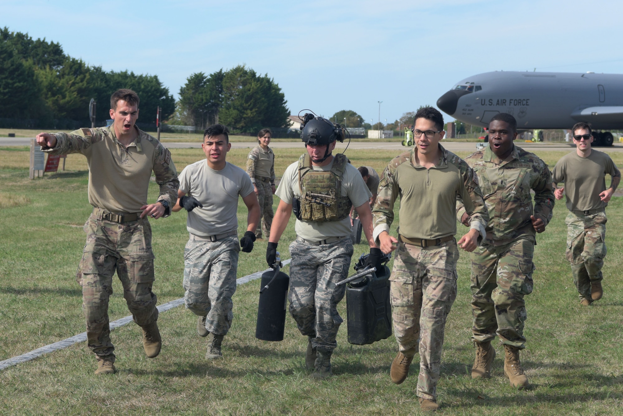 Airmen assigned to the 100th Logistics Readiness Squadron run together during a Forward Area Refueling Point team tryout at RAF Mildenhall, England, Sept. 13, 2019. During FARP training, members wear full body armor to simulate encounters they may face downrange while refueling. (U.S. Air Force photo by Senior Airman Benjamin Cooper)