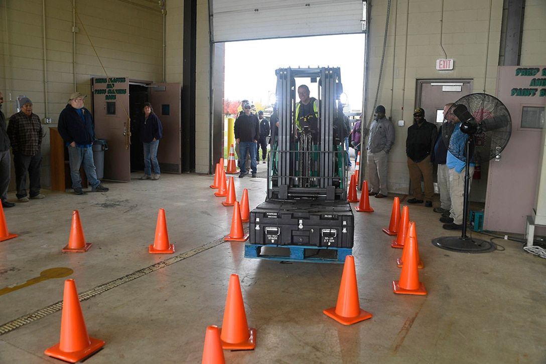 Trainer Don Zimmermann navigates a warehouse obstacle course during a safe operation demonstration at the MHE Safety Summit Oct. 25.
