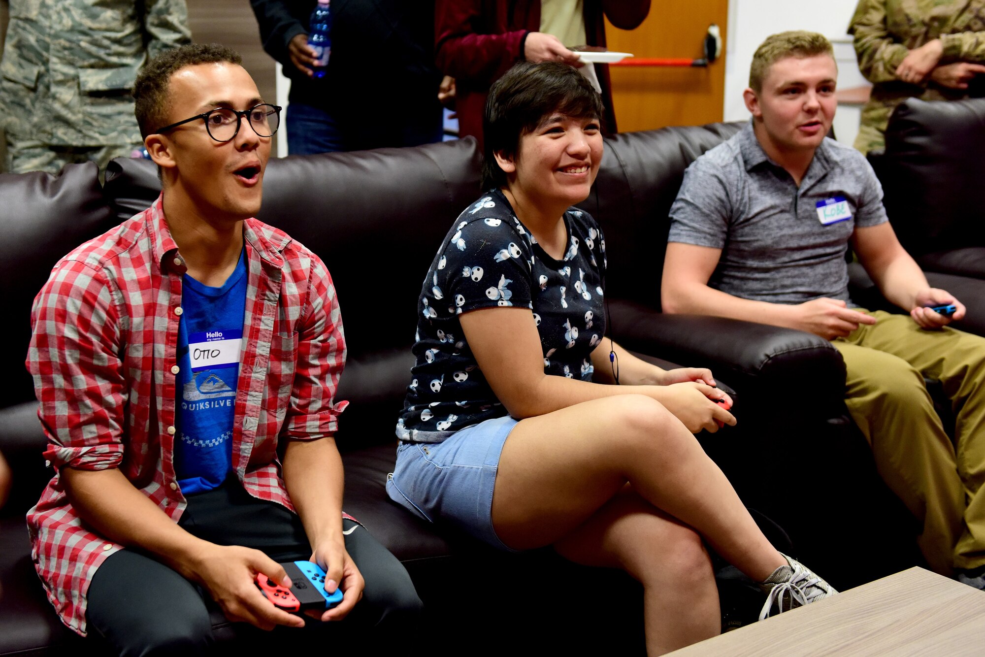 U.S. Airmen play video games during the Wyvern Refuge re-opening ceremony at Aviano Air Base, Italy, Oct. 25, 2019. The Refuge recently went through more than $17,000 worth of renovation, aimed towards offering Airmen E1 through E4 a place to meet and relax on base. (U.S. Air Force photo by Staff Sgt. Kelsey Tucker)