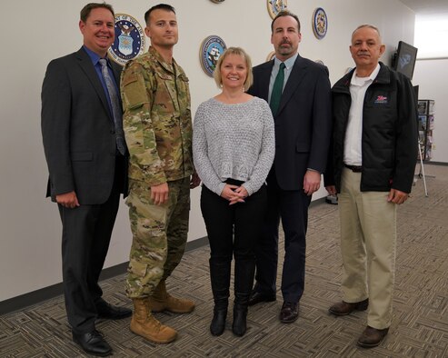 Five members serving with the U.S. Transportation Command’s Cyber Operations team that received the National Security Agency’s 2018 Frank B. Rowlett Trophy for Organizational Achievement are pictured. Standing left to right are Patrick Grimsley, deputy chief of Defensive Cyber Operations/Department of Defense Information Network Operations, Command, Control, Communications, and Cyber Systems Directorate, TCJ6; U.S. Air Force Capt. Christopher Green, executive officer to the TCJ6 director; Tina Burton, deputy Cybersecurity Service Provider manager, TCJ6; Matthew Cramer, senior intelligence analyst, Intelligence Directorate, TCJ2; and Wayne “Jake” Carson, chief, Mission Assurance Programs Branch, Operations Directorate, TCJ3. They and hundreds of their other command teammates earned this honor for the sixth time. The Organizational Achievement award recognizes the federal government agency, which makes the most significant contributions to the enhancement of national information systems security, operational information assurance readiness, or the defensive information operations posture of the United States.  In addition, Burton was named first runner-up in the NSA’s 2018 Frank B. Rowlett Trophy for Individual Achievement.  (Photo by Rob Wieland, USTRANSCOM/PA)