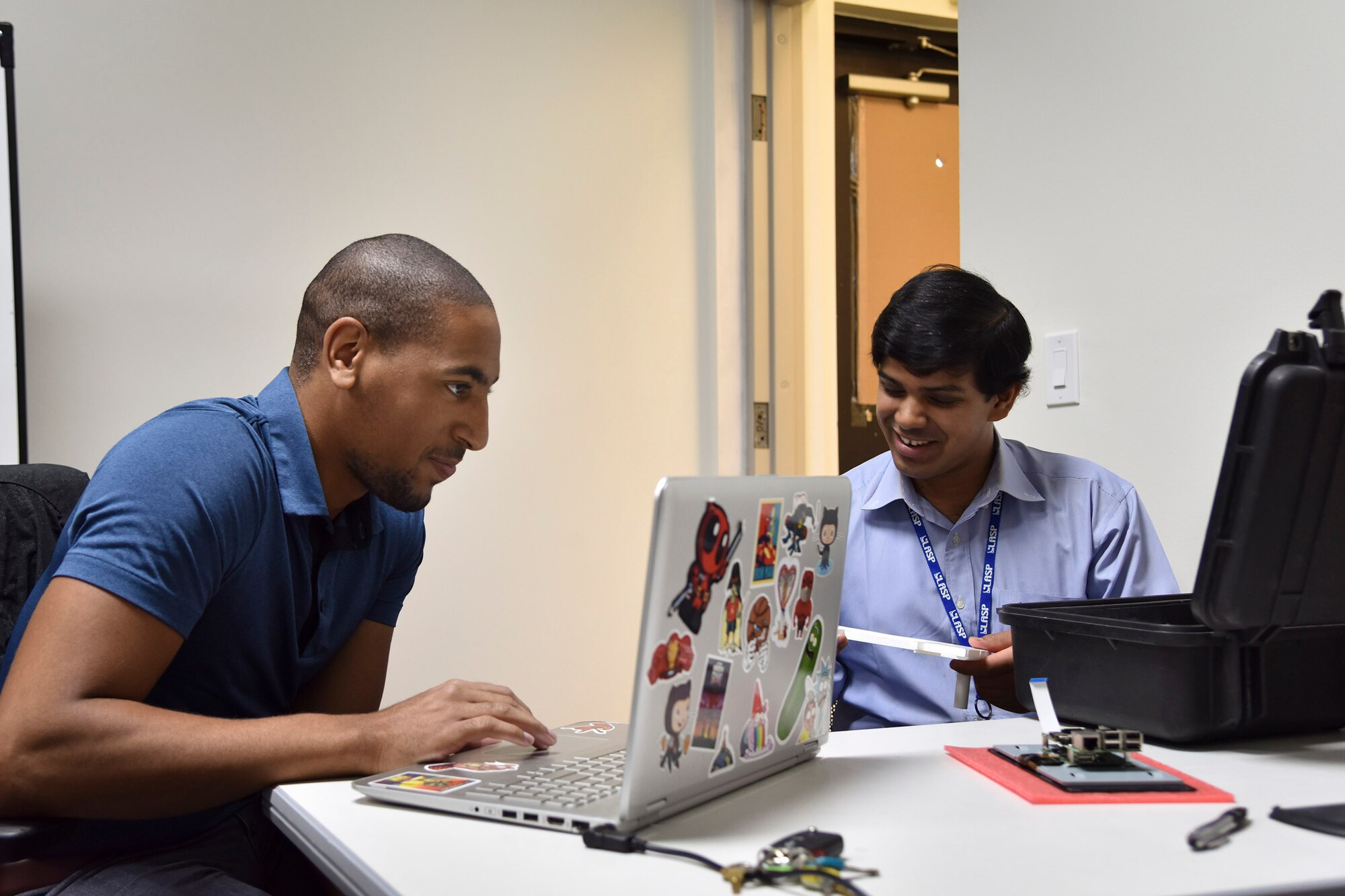 Myles Ross, a senior at North Carolina A&T State University, and Gautham Viswaroopan, a graduate student at the University of Colorado, Boulder, crunch some numbers during their fellowship with the Air Force Technical Applications Center, Cape Canaveral Air Force Station, Fla.  The students were part of the X-Force Fellowship Program, which gives matriculated graduate and undergraduate students the opportunity to work on and solve current and emerging DoD mission needs.  The program is sponsored by the National Security Innovation Network.  (U.S. Air Force photo by Matthew S. Jurgens)