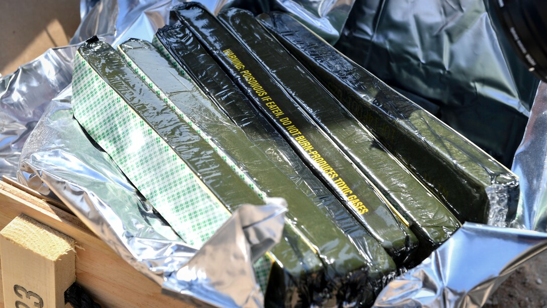 Blocks of C-4 explosives are laid out before an insensitive munitions disposal training at the Udari Range, Kuwait, Sept. 30, 2019. C-4, or Composition C-4, is a common variety of the plastic explosive family known as Composition C. C-4 is composed of explosives, plastic binder and plasticizer to make it malleable, and usually a marker or odorizing taggant. C-4 has a texture similar to modeling clay and can be molded into any desired shape. C-4 is metastable and can be activated by the shock wave from a detonator or blasting cap