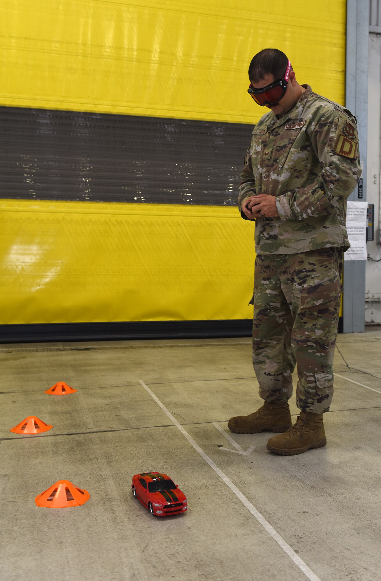 An Airman from the 100th Logistics Readiness Squadron attempts to steer a remote-control car through a mini course while wearing “drunk goggles” at an event to highlight the dangers of drunk driving at RAF Mildenhall, England, Oct. 11, 2019. Members of Suffolk Police, along with the 48th Medical Operations Squadron Alcohol and Drug Prevention and Treatment Program, attended the safety event to show the effects alcohol has on motor skills. (U.S. Air Force photo by Karen Abeyasekere)