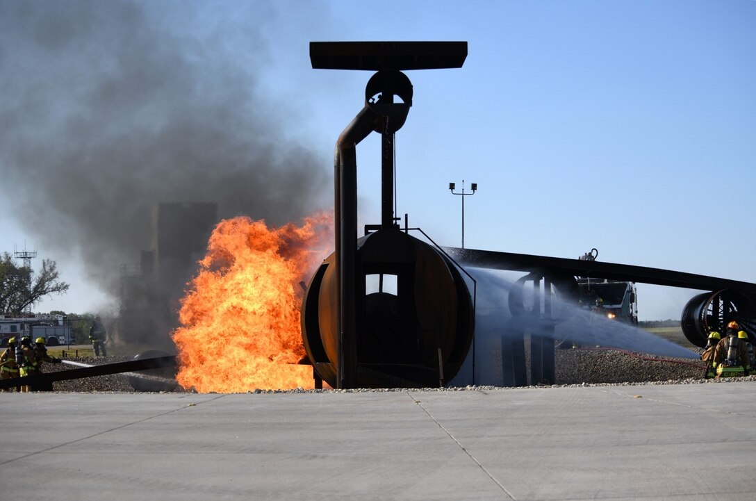 Firefighters from the Wichita Airport Police and Fire Department put out a fire on a large frame training aircraft Oct. 21, 2019, at McConnell Air Force Base, Kan. Live-fire training received by the WAPFD gave firefighters experience in controlling and extinguishing aircraft fires through realistic simulated conditions. (U.S. Air Force photo by Airman 1st Class Nilsa E. Garcia)