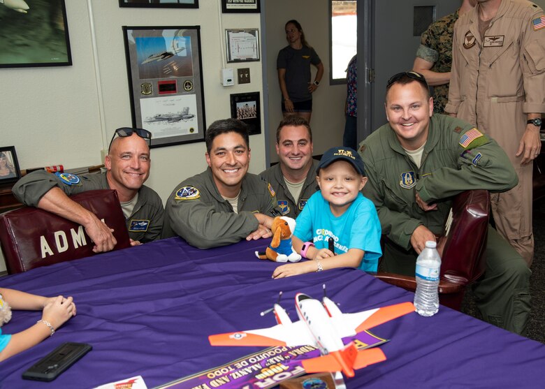 Corpus Christi, Texas Driscoll Children's Hospital patient, and Naval Air Station Corpus Christi Pilot for a Day Alessandra "Ale" Alaniz poses for a "hero" shot with her new Laughlin Air Force Base, Texas, aviation teammates (left to right) Lt. Col. Doug Hayes, 96th Flying Training Squadron; Capt. Roland Kern, 86th Flying Training Squadron; Capt. Anthony Giebelhaus, 86th FTS, and Maj. Wade Dahlgren, 96th FTS.  Ale is the 100th child selected for the NAS Corpus Christi program. (U.S. Air Force photo)