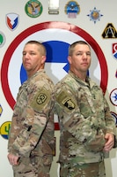 From left to right - Master Sgt. Joseph Howard, S-3 (operations) noncommissioned officer in charge (NCOIC), 450th Movement Control Battalion (MCB), and Master Sgt. Bryant Howard, Trans-Arabian Network (TAN) NCOIC, 450th MCB, stand back to back at Camp Arifjan, Kuwait, Oct. 24, 2019. This is Joseph and Bryant's third time being deployed together - being deployed together twice to Iraq in 2003 and 2009. (U.S. Army Reserve photo by Spc. Dakota Vanidestine)