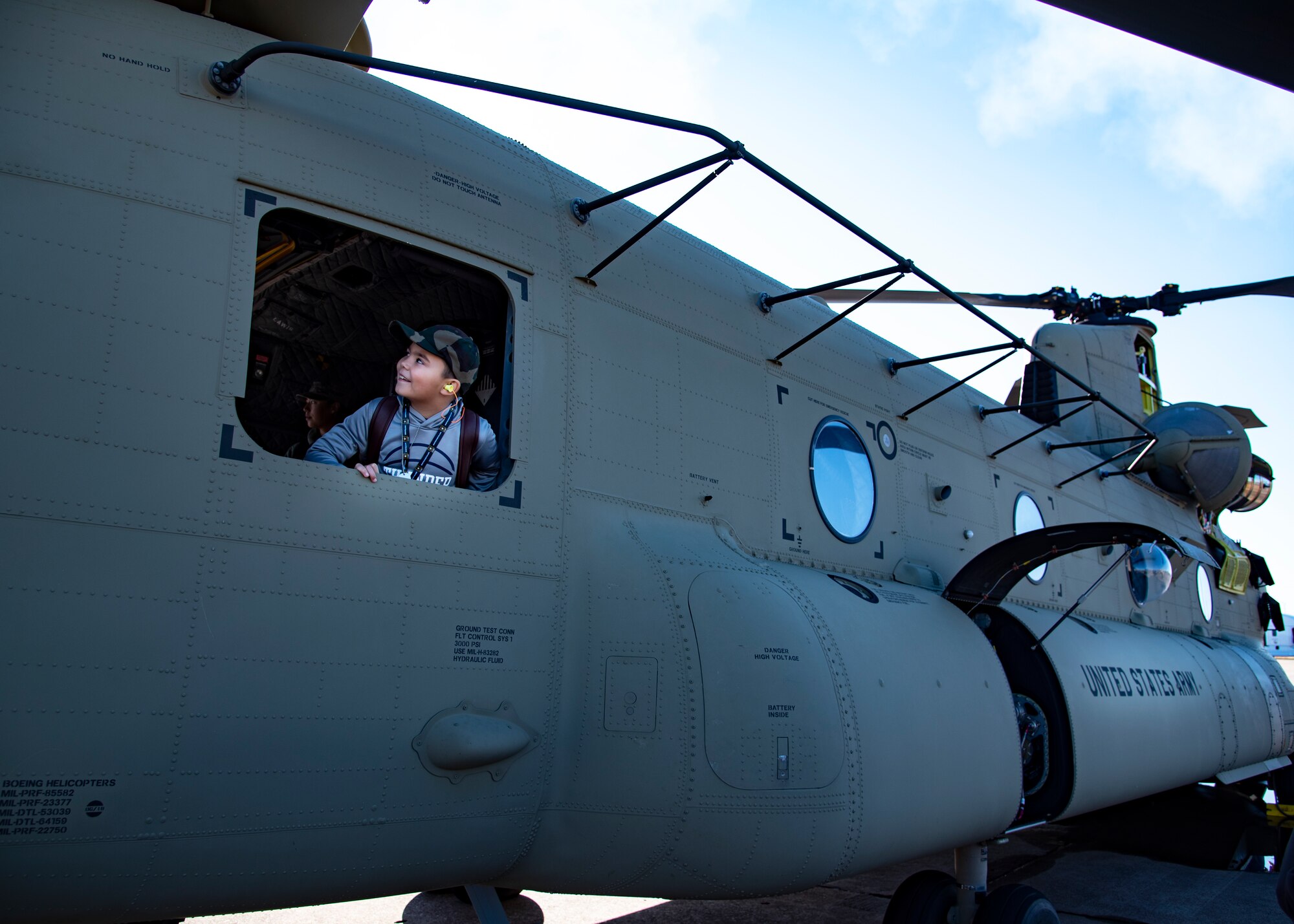 An event goer looks out of a CH-47 Chinook at the Sheppard Air Force Base Guardians of Freedom Open House and Air Show at Sheppard AFB, Texas, Oct. 27, 2019. The open house and air show was a opportunity for the local community to come and see some of the inner workings of Sheppard AFB. It also allowed Sheppard to educate the community on it's mission and the Air Force's role in defending freedom. There were also multiple recruiters to help educate the spectators as well. (U.S. Air Force photo by Airman 1st Class Pedro Tenorio)