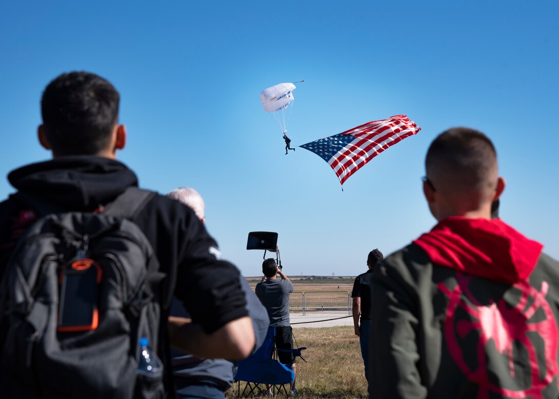 Event goers watch a U.S. Air Force Academy Wings of Blue parachute team member at the Sheppard Air Force Base Guardians of Freedom Open House and Air Show at Sheppard AFB, Texas, Oct. 27, 2019. The open house and air show is a chance for Sheppard to show and communicate the Air Force's mission as well as Sheppard's specific mission of training, developing and inspiring the next generation of Air Force warriors. (U.S. Air Force photo by Airman 1st Class Pedro Tenorio)