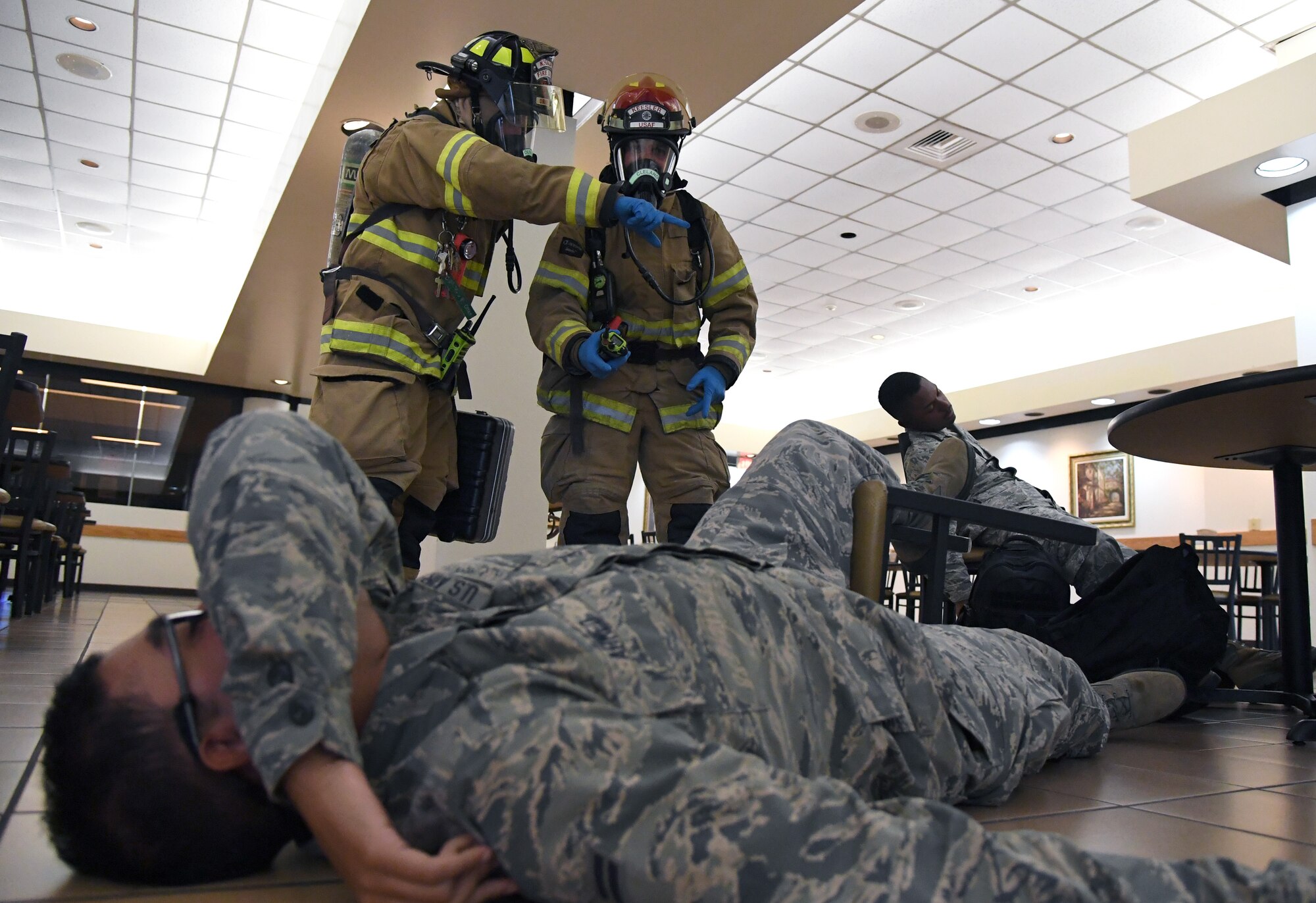 Christopher Oliver and David Cleland, 81st Infrastructure Division firefighters, assess the scene during the Anti-Terrorism, Force Protection Condition and Chemical, Biological, Radiological, Nuclear and high-yield Explosives training exercise near the Live Oak Dining Facility at Keesler Air Force Base, Mississippi, Oct. 24, 2019. The exercise scenario simulated a gym bag with ricin found by Keesler personnel who alerted first responders. The exercise was conducted to evaluate the mission readiness and security of Keesler. (U.S. Air Force photo by Kemberly Groue)